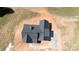 Overhead view of a new home's sleek black roof and concrete driveway on large lot at 4648 Simpson Rd, Edgemoor, SC 29712