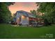 Expansive backyard featuring a covered porch and an outdoor kitchen with bar seating at 4877 River Hills Dr, Denver, NC 28037