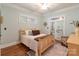 Cozy bedroom with hardwood floors, a wooden bed frame, and access to an outdoor area at 4877 River Hills Dr, Denver, NC 28037