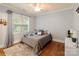 Bright bedroom featuring hardwood floors, large window, and cozy furnishings at 4877 River Hills Dr, Denver, NC 28037