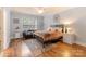 Comfortable bedroom features a seating area, large window, and neutral decor at 4877 River Hills Dr, Denver, NC 28037
