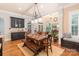 Bright dining area features hardwood floors, modern lighting, and a built in bar and cabinet area at 4877 River Hills Dr, Denver, NC 28037