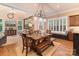 Charming dining area with wood floors, bench seating, lots of natural light, and an adjacent living space at 4877 River Hills Dr, Denver, NC 28037