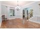 Elegant dining room featuring hardwood floors, an ornate chandelier, and access to a staircase at 4877 River Hills Dr, Denver, NC 28037