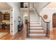 Elegant foyer with a staircase, hardwood floors, and an open floor plan at 4877 River Hills Dr, Denver, NC 28037