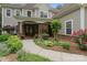 Inviting front entrance with stone accents and a beautifully landscaped garden at 4877 River Hills Dr, Denver, NC 28037