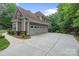 Spacious three-car garage with an extended driveway and an American flag at 4877 River Hills Dr, Denver, NC 28037