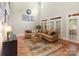 Bright living room boasts soaring ceilings, neutral decor, and an array of windows and doors at 4877 River Hills Dr, Denver, NC 28037
