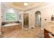 Luxurious primary bathroom features a soaking tub, walk-in shower, and tile flooring at 4877 River Hills Dr, Denver, NC 28037