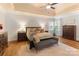 Bright bedroom features shiplap walls, tray ceiling, and hardwood floors at 4877 River Hills Dr, Denver, NC 28037