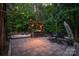Charming outdoor kitchen and entertaining area with a pergola and stone patio at 4877 River Hills Dr, Denver, NC 28037