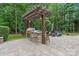 Outdoor kitchen and patio featuring a stone counter with built-in grill and pergola at 4877 River Hills Dr, Denver, NC 28037