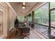 Spacious screened porch with ceiling fans, dining table and view of the treed backyard at 4877 River Hills Dr, Denver, NC 28037