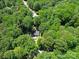 Secluded home surrounded by lush greenery, offering privacy and a peaceful retreat from the everyday hustle at 4901 Pine Oaks Dr, Monroe, NC 28112