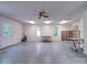 Open basement space with natural light, drop ceiling, and potential for various uses at 4901 Pine Oaks Dr, Monroe, NC 28112