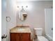 Bathroom featuring granite vanity, round mirror and tub with shower at 4901 Pine Oaks Dr, Monroe, NC 28112