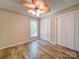 This bedroom features a ceiling fan, new floors, and closet at 4901 Pine Oaks Dr, Monroe, NC 28112