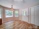 Cozy dining area featuring hardwood floors, ample natural light, and adjacent access to an exterior door at 4901 Pine Oaks Dr, Monroe, NC 28112