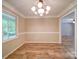 Bright dining room with decorative lighting and new floors at 4901 Pine Oaks Dr, Monroe, NC 28112