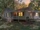 Charming home with inviting front porch and manicured landscaping at dusk at 4901 Pine Oaks Dr, Monroe, NC 28112