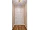 This hallway has new hardwood flooring, fresh paint, and a modern lighting fixture at 4901 Pine Oaks Dr, Monroe, NC 28112