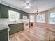This eat-in kitchen features olive green cabinets, modern white appliances, and ample natural light from the windows at 4901 Pine Oaks Dr, Monroe, NC 28112