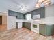 Well-lit kitchen features green cabinets, white appliances, and wood-look flooring, offering a functional space at 4901 Pine Oaks Dr, Monroe, NC 28112