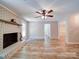 Spacious living room features a brick fireplace, wood-look floors, and neutral paint for a comfortable atmosphere at 4901 Pine Oaks Dr, Monroe, NC 28112