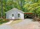 This outbuilding features covered parking and a storage area, adding functionality to the property at 4901 Pine Oaks Dr, Monroe, NC 28112