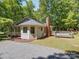Property showing a well-maintained exterior, deck, gravel driveway and partially wooded lot at 4901 Pine Oaks Dr, Monroe, NC 28112