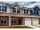 Newly built townhomes with brick facades, garages, and well-maintained lawns at 5149 Tommy Ln # 1102, Stanley, NC 28164