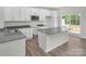 Stylish kitchen with white cabinetry, island, and stainless steel appliances at 5149 Tommy Ln # 1102, Stanley, NC 28164