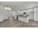Contemporary kitchen features white cabinets, modern appliances, and island at 5149 Tommy Ln # 1102, Stanley, NC 28164