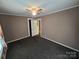 The bedroom has neutral paint and carpet, plus an open closet and ceiling fan at 5501 Barrier Rd, Concord, NC 28025