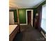 Bedroom featuring green walls, a four-poster bed, and a window with natural light at 5501 Barrier Rd, Concord, NC 28025