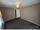 The bedroom has neutral paint and carpet, plus an open closet and ceiling fan at 5501 Barrier Rd, Concord, NC 28025