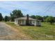 Charming single-story home with a brick chimney and a metal roof set on a spacious lot with mature trees at 5501 Barrier Rd, Concord, NC 28025