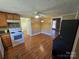 Well-lit eat-in kitchen area featuring warm wood cabinets, a mosaic tile backsplash, and sleek vinyl floors at 5501 Barrier Rd, Concord, NC 28025