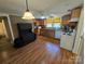 This kitchen has wood cabinets, and white appliances, plus vinyl flooring at 5501 Barrier Rd, Concord, NC 28025