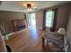 Bright living room with hardwood floors, brick fireplace, and natural light streaming through the windows at 5501 Barrier Rd, Concord, NC 28025