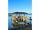 Daytime view of a waterfront dock with boat lift, seating area, and clear blue sky at 578 Stonemarker Rd, Mooresville, NC 28117