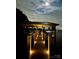 A waterfront dock featuring a covered boat slip and walkway lights under a beautiful moonlit sky at 578 Stonemarker Rd, Mooresville, NC 28117
