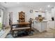 Open dining area featuring wood table and seating next to the kitchen with natural light at 584 Lamorak Pl, Richburg, SC 29729