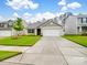 Charming home with a two-car garage, well-manicured lawn, and inviting curb appeal at 584 Lamorak Pl, Richburg, SC 29729