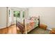 Cozy bedroom featuring a large window, hardwood floors, and colorful bedding at 5903 Wm Griffin Rd, Monroe, NC 28112