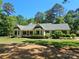 Charming single-story home featuring a well-manicured lawn, lush greenery, and a welcoming screened porch at 5903 Wm Griffin Rd, Monroe, NC 28112