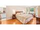 Sun-filled bedroom with hardwood floors, neutral walls, and a large window at 5903 Wm Griffin Rd, Monroe, NC 28112