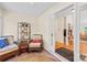Cozy sunroom featuring tile flooring, wicker furniture, and an open doorway at 5903 Wm Griffin Rd, Monroe, NC 28112