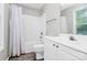A well-lit bathroom featuring a shower/tub combo, single sink, and modern fixtures at 5943 Pisgah Way, Charlotte, NC 28217