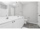 A well-lit bathroom features a double vanity, tile floors and modern fixtures at 5943 Pisgah Way, Charlotte, NC 28217